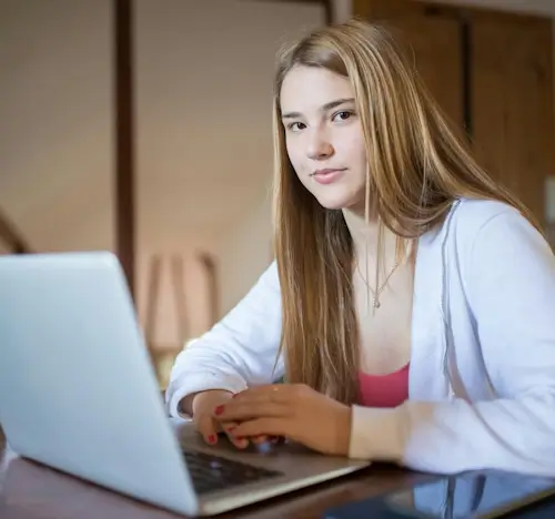 Student using a laptop computer form online lessons